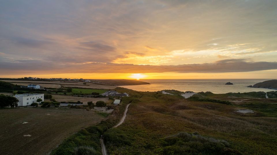 Off-mains homes on the north Cornwall coast at sunset