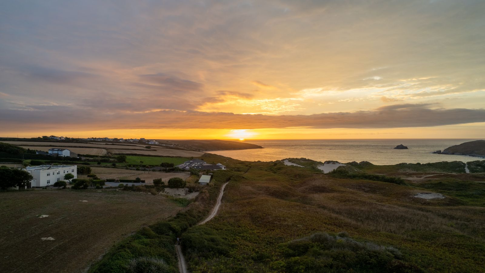 Off-mains homes on the north Cornwall coast at sunset